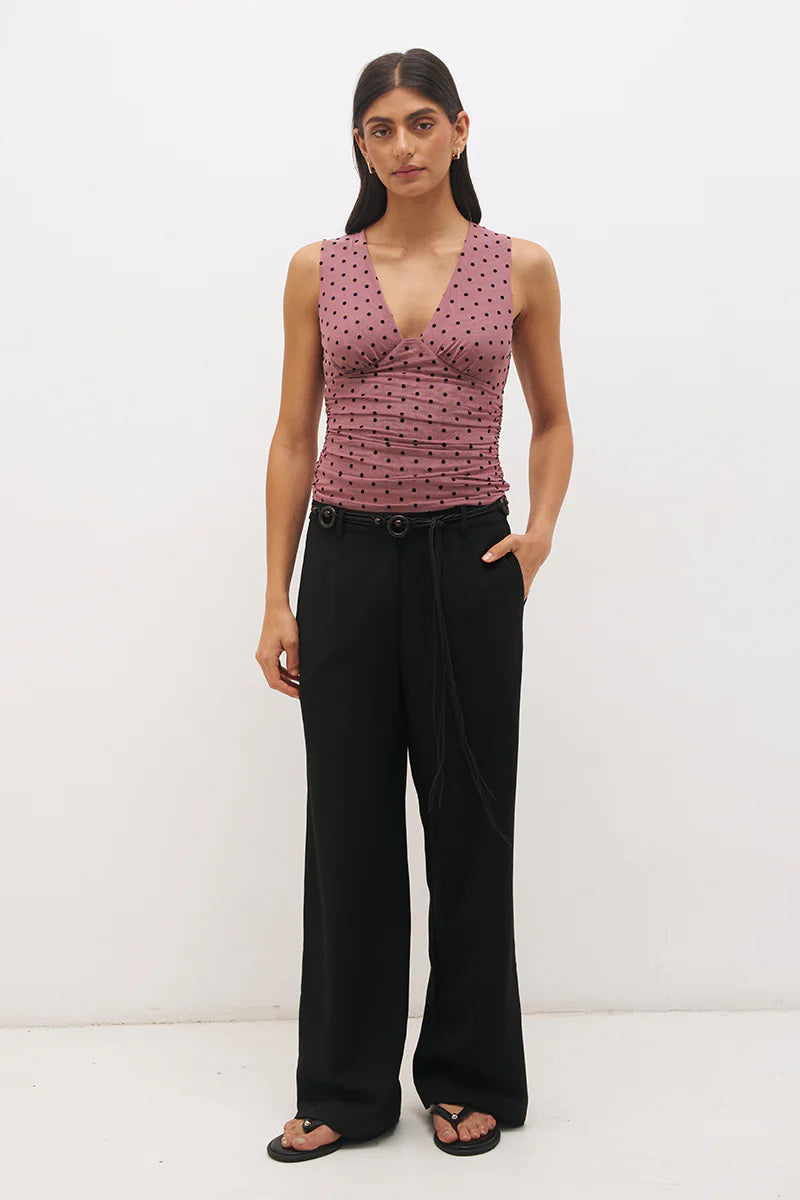 Mon Renn Sonata Spot Top in Rosewood And Black — full length front view showing plunging angled V-neckline and ruched empire bodice in flocked rosewood polka dot mesh, styled with black wide-leg trousers