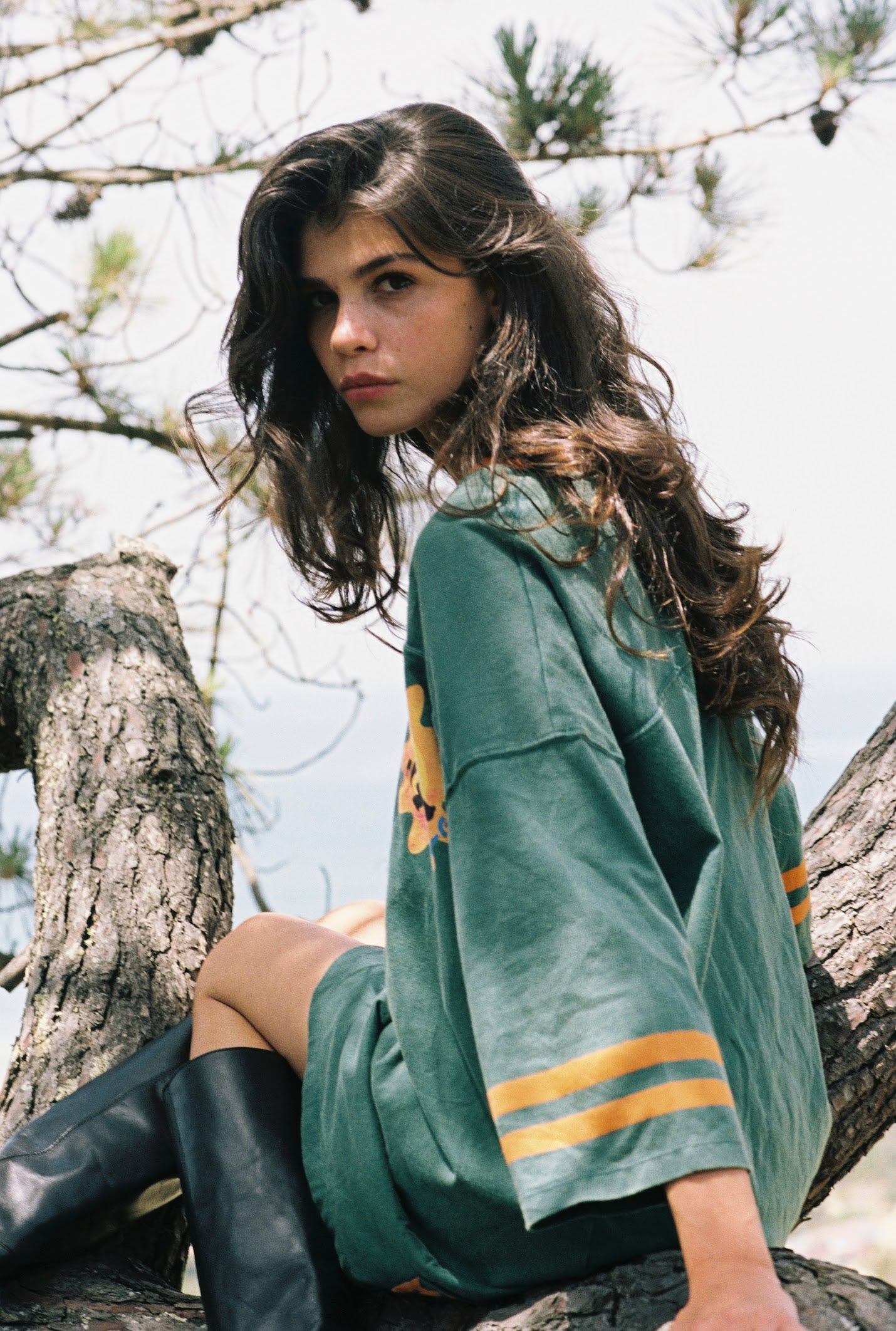 Kinga Csilla 77 Sun Team Tee Dress in forest green — mini length jersey dress worn as a top, layered over midi skirt