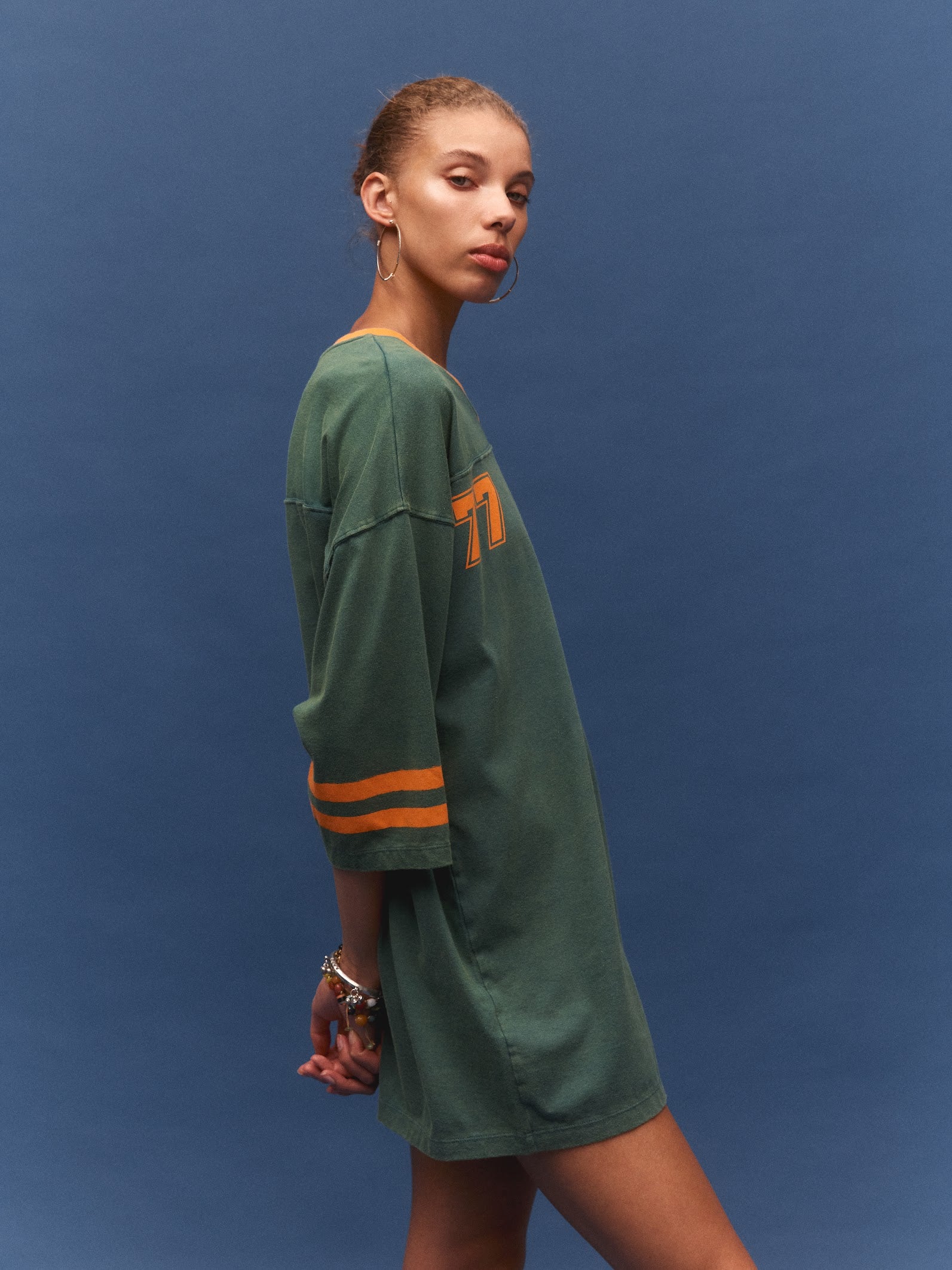 Kinga Csilla 77 Sun Team Tee Dress in forest green — side view showing relaxed fit and mini length