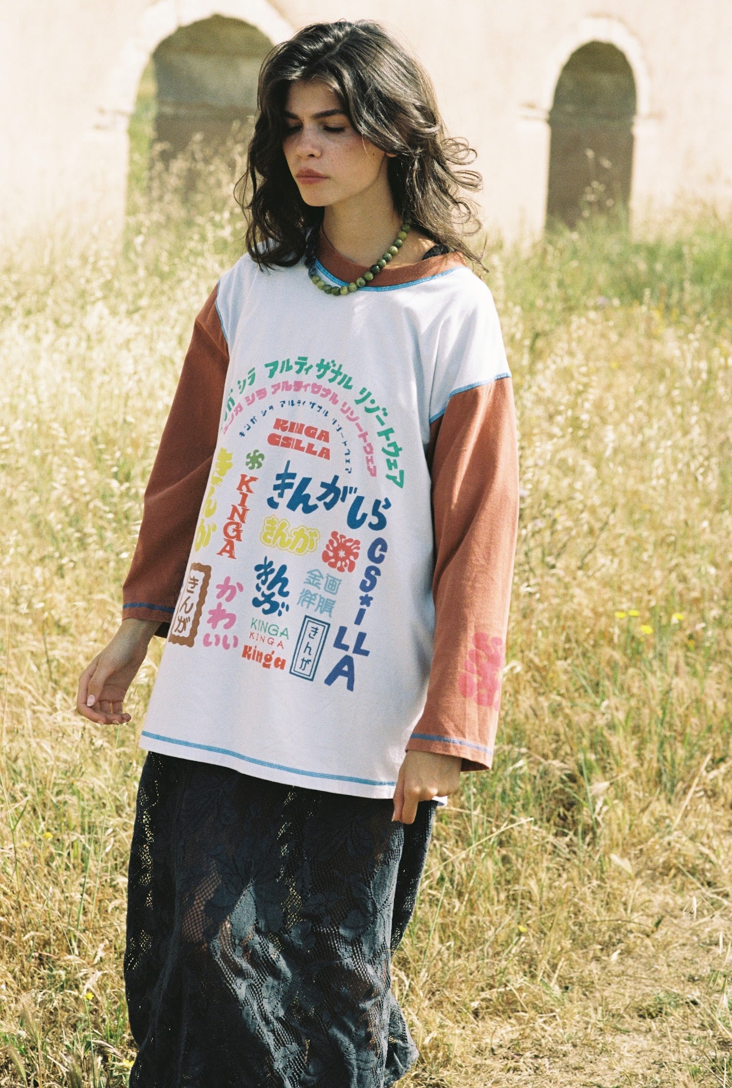 Kinga Csilla Japanese Sunset Tommy Tee in white — blue topstitching detail at neckline, rust 3/4 sleeves with illustrated graphic art