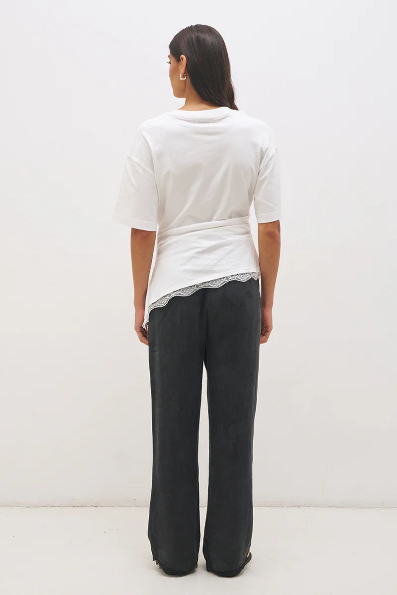 Mon Renn Liora T-Shirt in Off White — back view showing clean silhouette with cinched waist and angled lace hem trim in off-white cotton