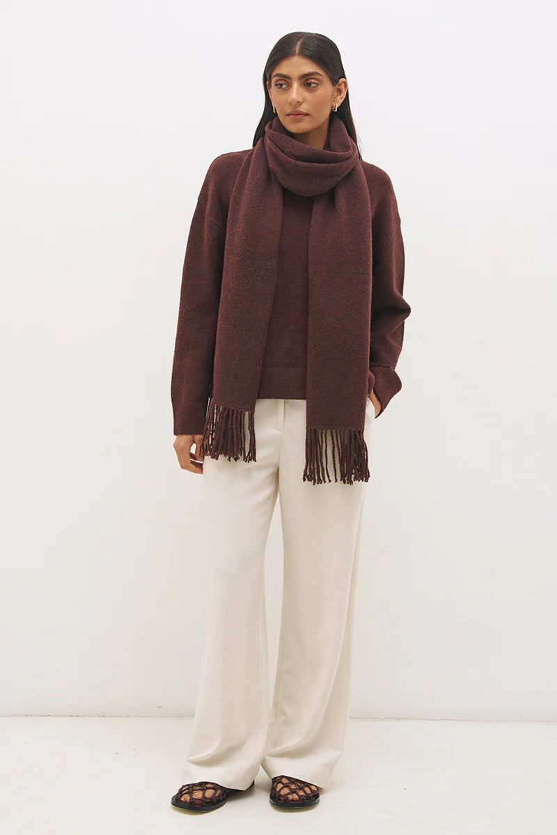 Mon Renn Scarf Knit Jumper in Cacao — full length front view with removable scarf draped and fringe tassels, styled with ivory wide-leg trousers