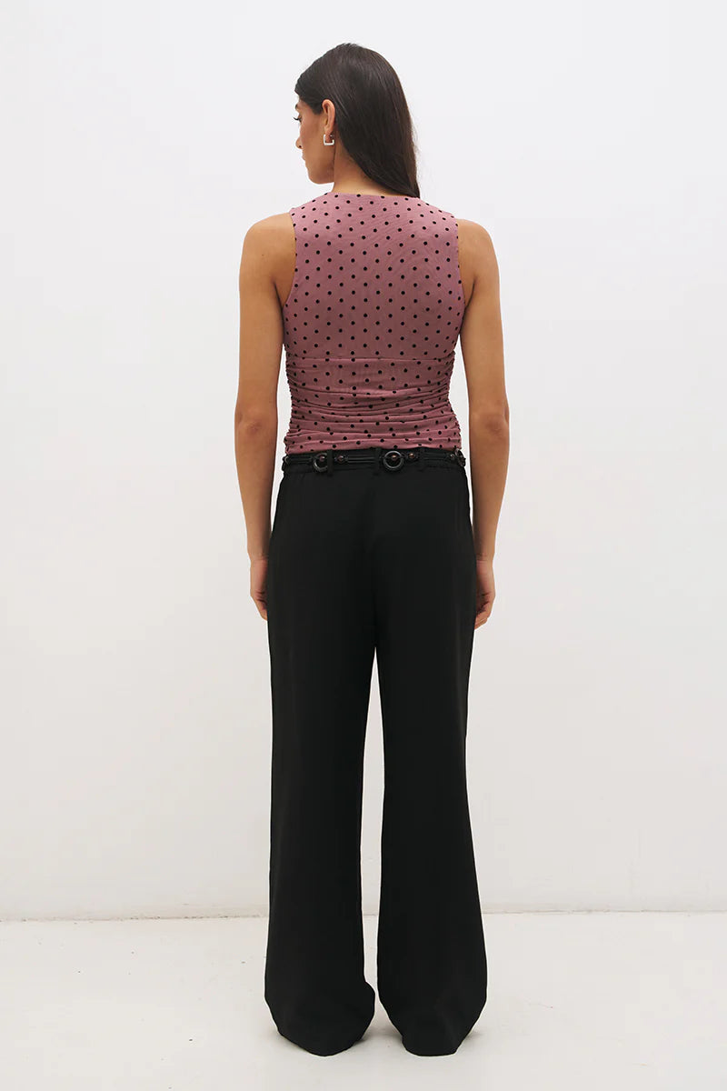 Mon Renn Sonata Spot Top in Rosewood And Black — back view showing ruched back, flocked polka dot mesh and sleeveless construction with black wide-leg trousers