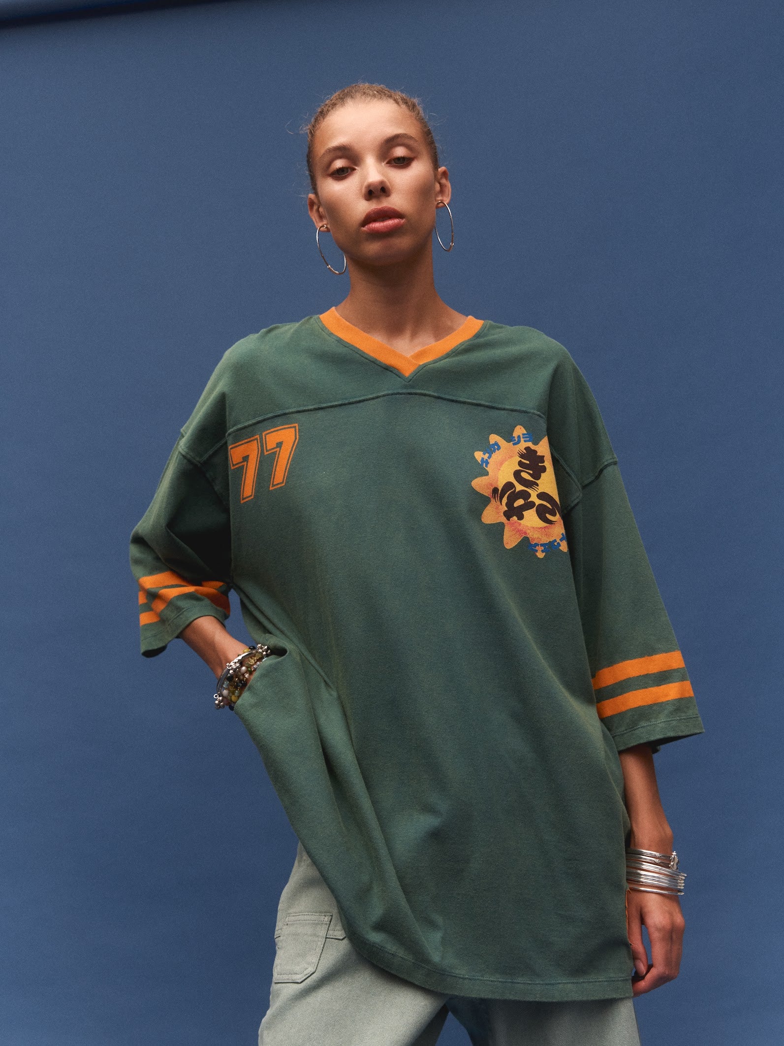 Kinga Csilla 77 Sun Team Tee Dress in forest green — full-length view of jersey mini dress with orange contrast trim throughout
